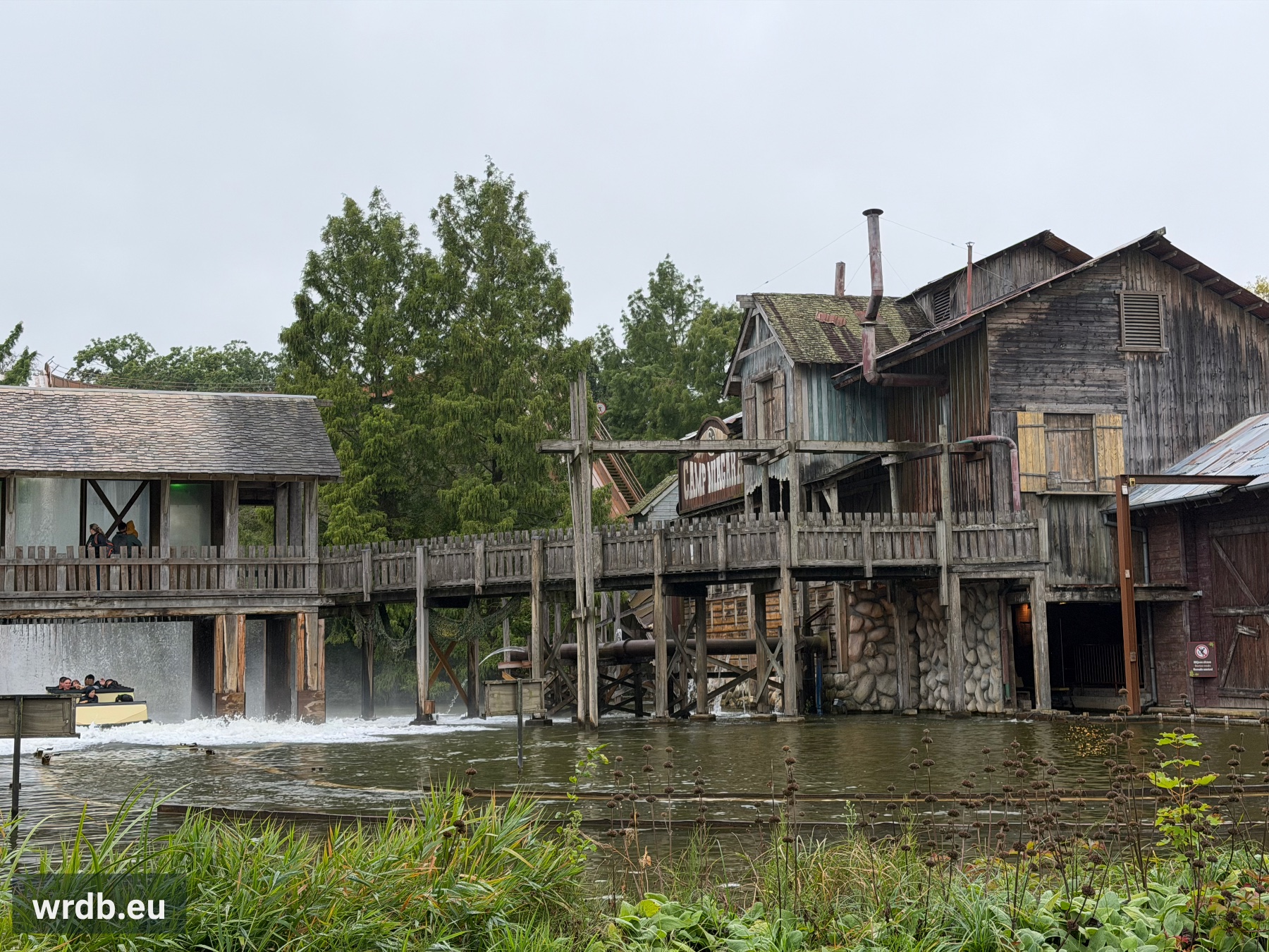 the station building at the right and a just landed boat at the left