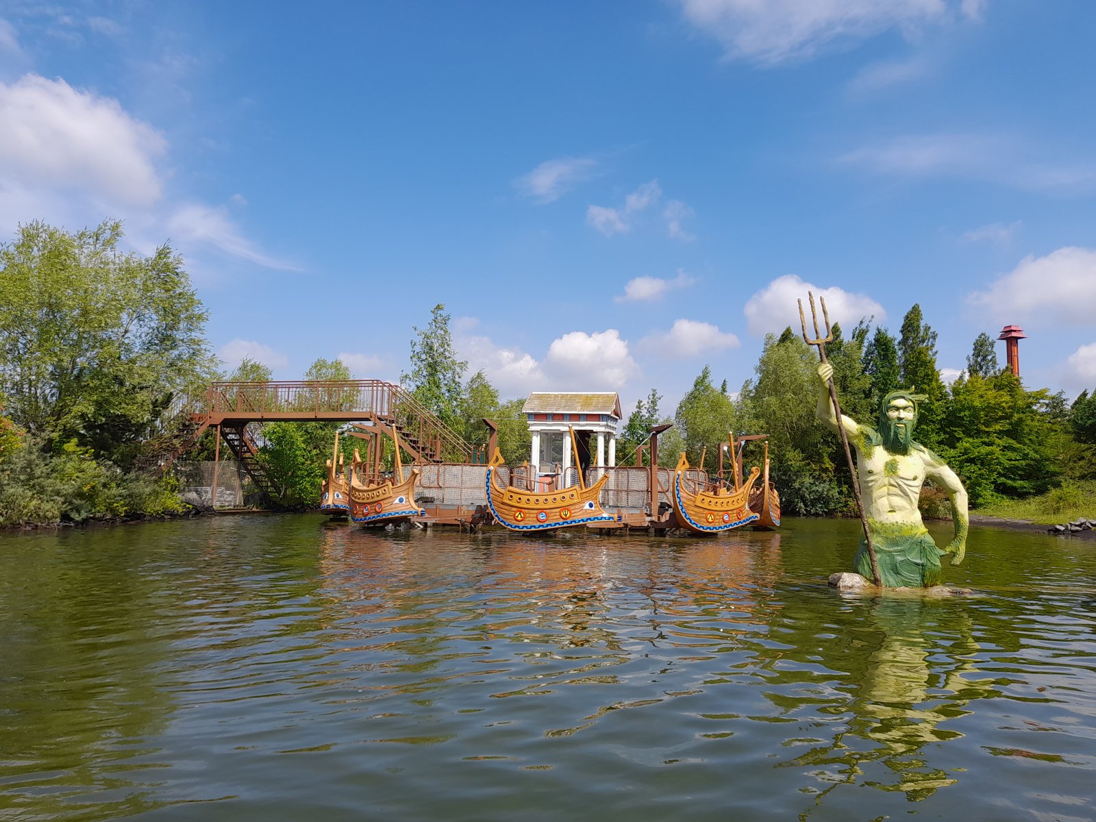 The boats of Poseidons Flotte at Belantis, with the Poseidon statue in the lake
